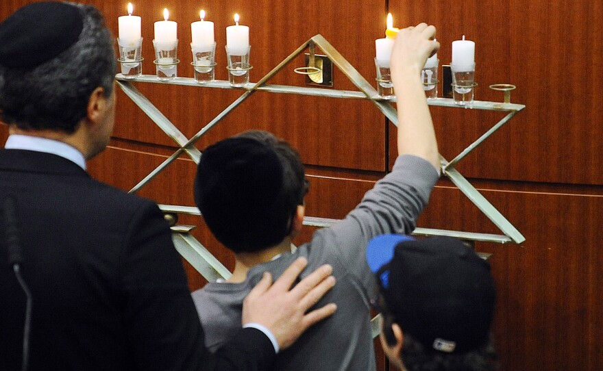 Candles are lit in Toulouse, southwestern France, in 2013 to honor the anniversary of a shooting there. Anti-Semitism is part of the rising emigration from France to Israel.