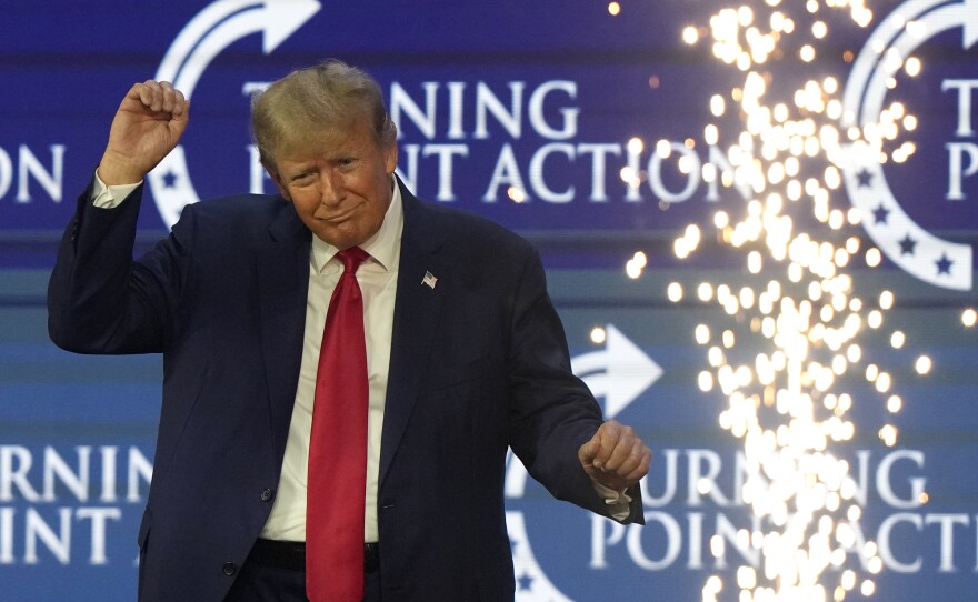 Former President Donald Trump dances on stage at the Turning Point Action conference on July 15.