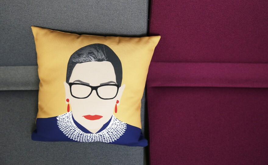 A pillow with Ruth Bader Ginsburg's likeness on it sits on a couch inside the office of ActBlue, a Democratic fundraising platform, in Somerville, Mass.