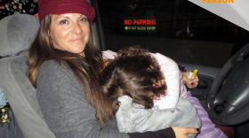 Lola Cheatham is holding her 3-year-old daughter after she fell asleep in her arms, Feb. 15, 2018.