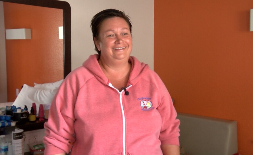 Sharna Barron, an Oceanside Homeless Resource client, stands in her motel room at the Carlsbad Village Inn. June 21, 2021.