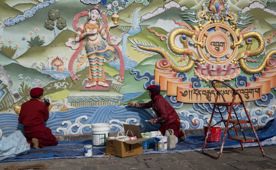 The nuns paint a wall at their compound.