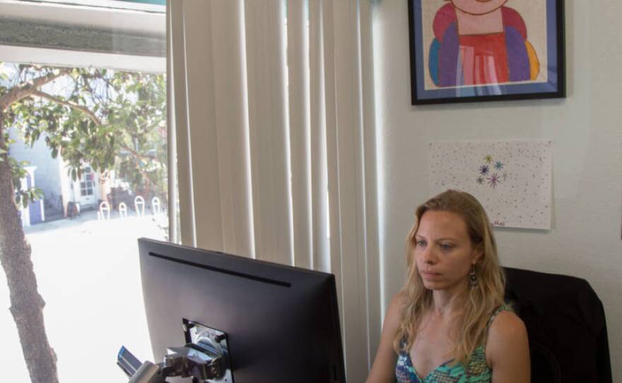 Kelly Wells works in the small office she shares with other immigration attorneys at Dolores Street Community Services in San Francisco, California in this undated photo.