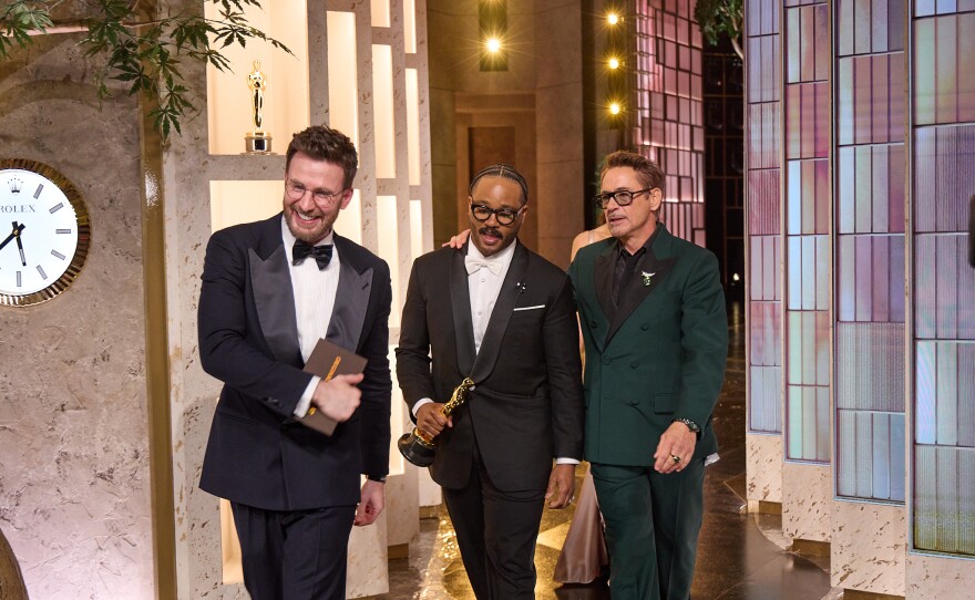 Chris Evans, Ryan Coogler and Robert Downey Jr. exit the stage after presenting the Oscar® for Adapted Screenplay to Paul Thomas Anderson during the 98th Oscars® at the Dolby® Theatre at Ovation Hollywood on Sunday, March 15, 2026.