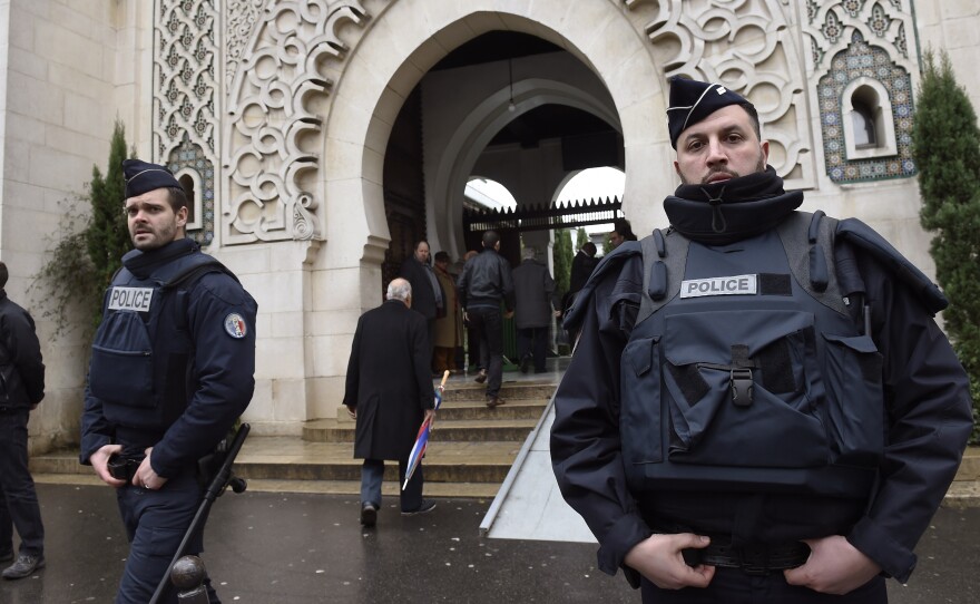 French police officers stand guard outside Paris' Grand Mosque on Jan. 9, as the city remained under siege as a hostage-taking crisis unfolded at a kosher supermarket. Nonetheless, the mosque's grand mufti says there are no plans to add any additional security of its own.