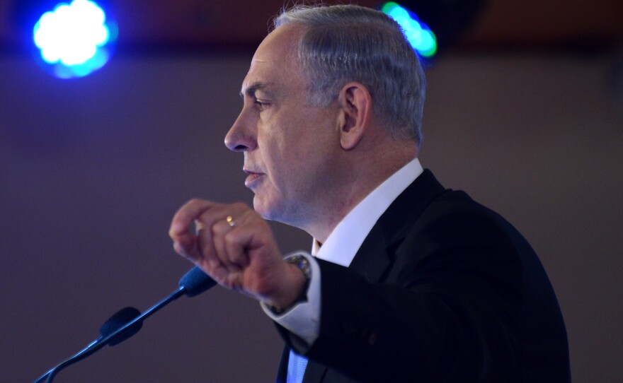 Israeli Prime Minister Benjamin Netanyahu, seen here speaking Monday, is under fire over a report of lavish spending.