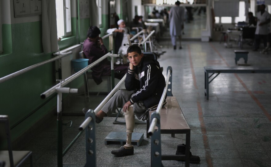 Abdullah, 13, lost his left leg when he stepped on an improvised explosive device. He takes a break from walking practice at the International Committee of the Red Cross physical rehabilitation center in Kabul on Dec. 1, 2019.