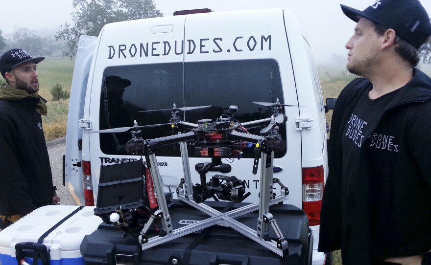 Andrew Petersen (left) and Jeff Blank unload their drone van in the early morning. Their business is one of many start ups that advertise aerial cinematography services by drone.