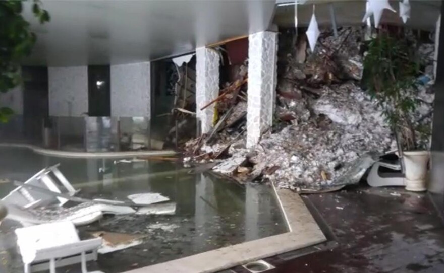 A screenshot from a video shows piles of snow and rubble cascading down the stairway into the foyer of the Hotel Rigopiano on early Thursday.