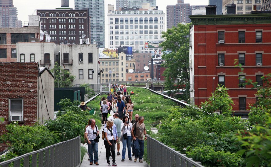 Pedestrians stroll on New York's High Line, a public park that has been constructed on the remains of an abandoned elevated railroad in Manhattan.