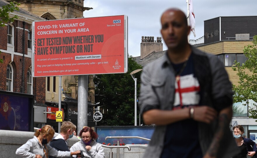 A sign urges people to get tested for a COVID-19 variant in Blackburn, England. The U.K. is experiencing a surge in the Delta variant, which was first identified in India.