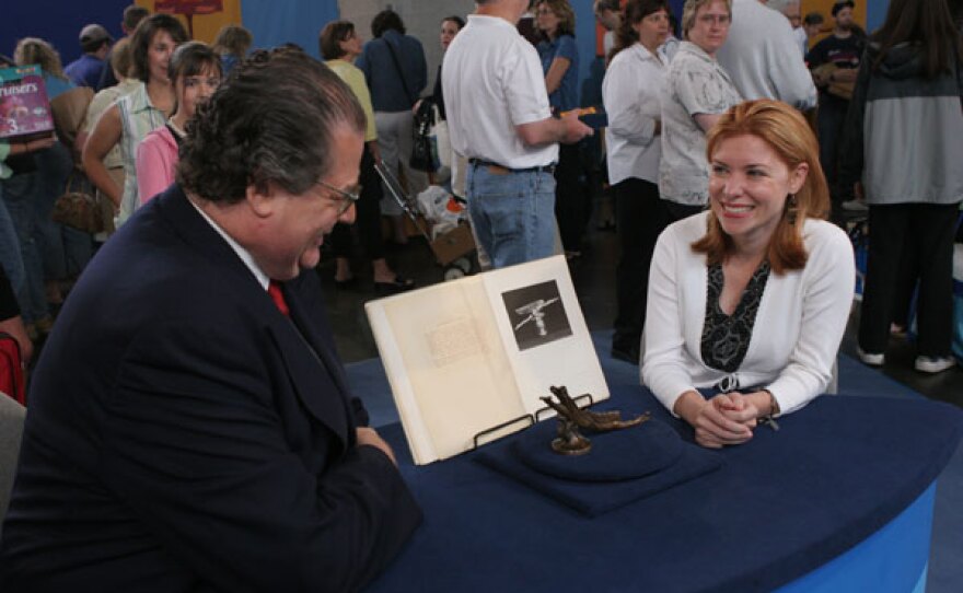 Eric Silver (left) appraises a 1923 Harriet Frishmuth hood ornament in Providence, R.I.