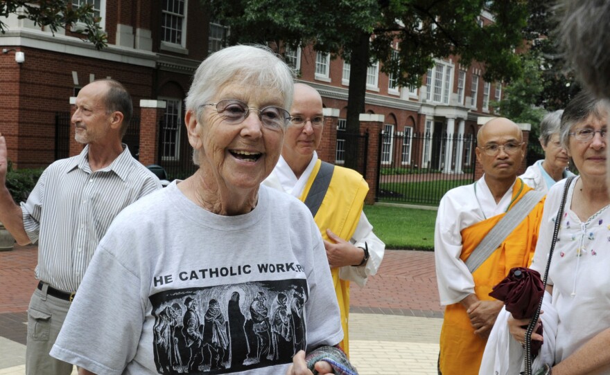 Sister Megan Rice, center, and Michael Walli, in the background waving, are greeted by supporters in 2012 as they arrive for a federal court appearance in Knoxville, Tenn., after being charged with sabotaging a government nuclear complex. Rice died on Oct. 10 in Rosemont, Pa. She was 91.