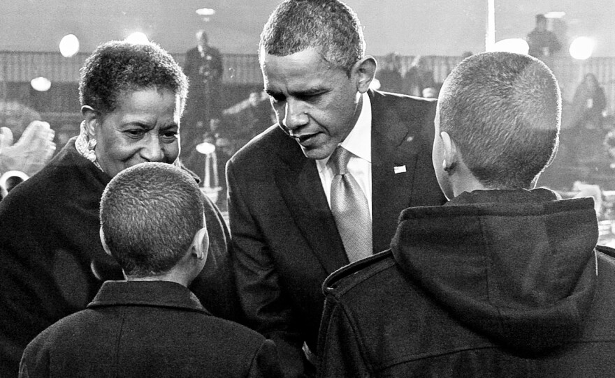 At his second inauguration, President Barack Obama speaks with Nolan (12) and Alex (13) Evers about the importance of their grandfather Medgar's work, as their grandmother, Myrlie Evers-Williams, looks on.