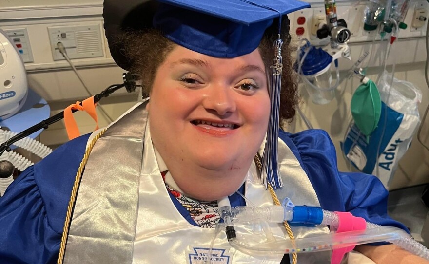 Alexis Ratcliff, in cap and gown for the invitations she sent for her high school graduation. It took a judge's order to tell the hospital to help her leave the hospital and attend her graduation ceremony.