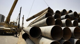 Cranes move materials at a construction site in central Baghdad in May. The U.S. government has spent more than $770 billion on private contractors in Afghanistan and Iraq since the wars began. U.S. prosecutors increasingly are targeting bribery schemes, but their efforts have been criticized for employing strong-arm tactics designed for terrorism cases.
