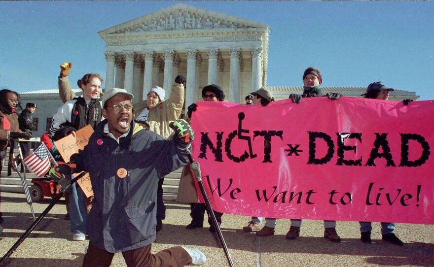 A sign reads "Not Dead. We want to live." With gripping stories and a personal mission, "Life After" explores who gets real choice, and who doesn't, in life and death.