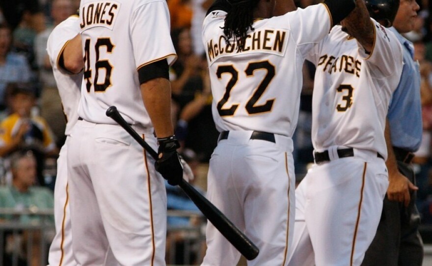 Pittsburgh Pirates players celebrate after scoring against the St. Louis Cardinals on Wednesday. It was a rare win for the team with the worst record in baseball this year.
