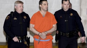 In this March 17, 2005 file photo Scott Peterson is escorted by two San Mateo County Sheriff deputies as he is walked from the jail to a waiting van in Redwood City, Calif. 