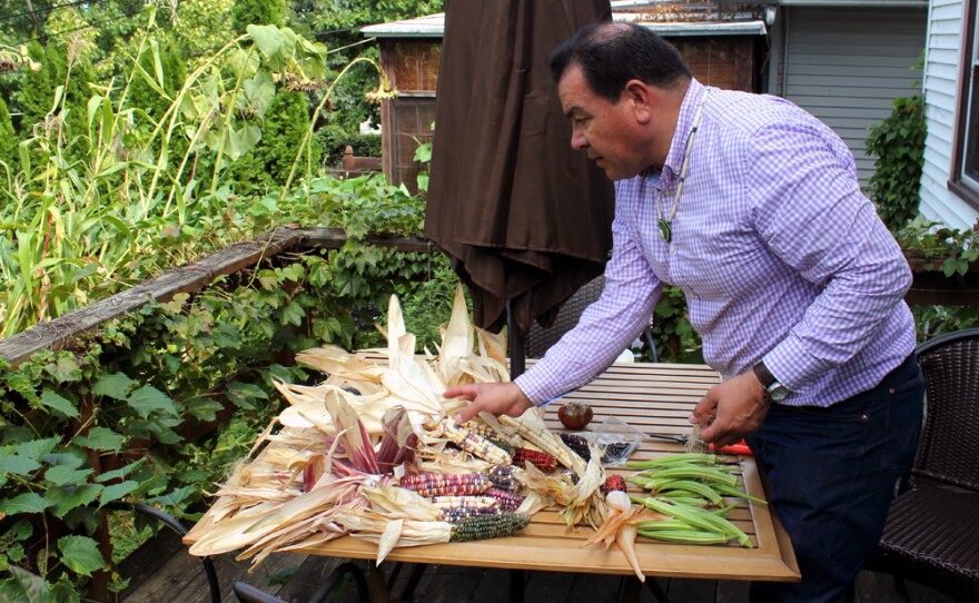 Taylor Keen sorts through the varieties of corn and other crops he has harvested from his backyard farm.