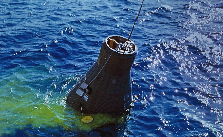 The Friendship 7 capsule containing Glenn is recovered from the Atlantic by the destroyer USS Noa. The yellow coloring in the water is dye to make the capsule more visible to the recovery crew.