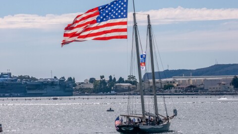 A ship flys the American Flag during the San Diego Fleet Week Veterans Day Boat Parade in the San Diego Bay on Nov. 11 2022.