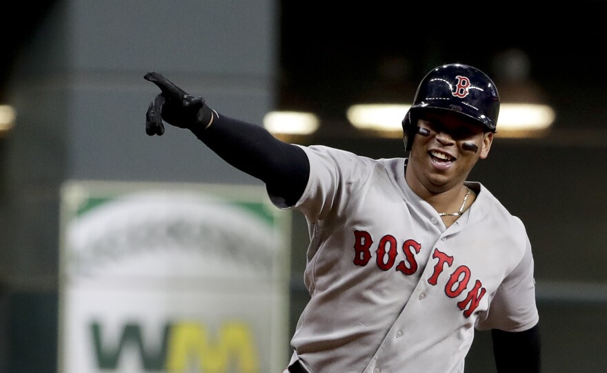 The Boston Red Sox's Rafael Devers celebrates his three-run home run Thursday against the Houston Astros during the sixth inning in Game 5 of a baseball American League Championship Series  in Houston. The Red Sox won 4-1 and will return to the World Series.
