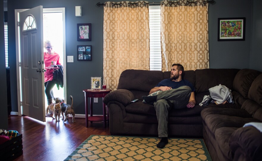 Harris rests after his shift at Cooper Standard as his wife, Summer, gets home from work. Harris gets a few hours to have dinner and unwind before heading to class four days each week.