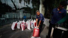 Workers place sandbags outside a restaurant as Hurricane Simon approaches Puerto Vallarta, Mexico, Saturday, Oct. 10, 2026.