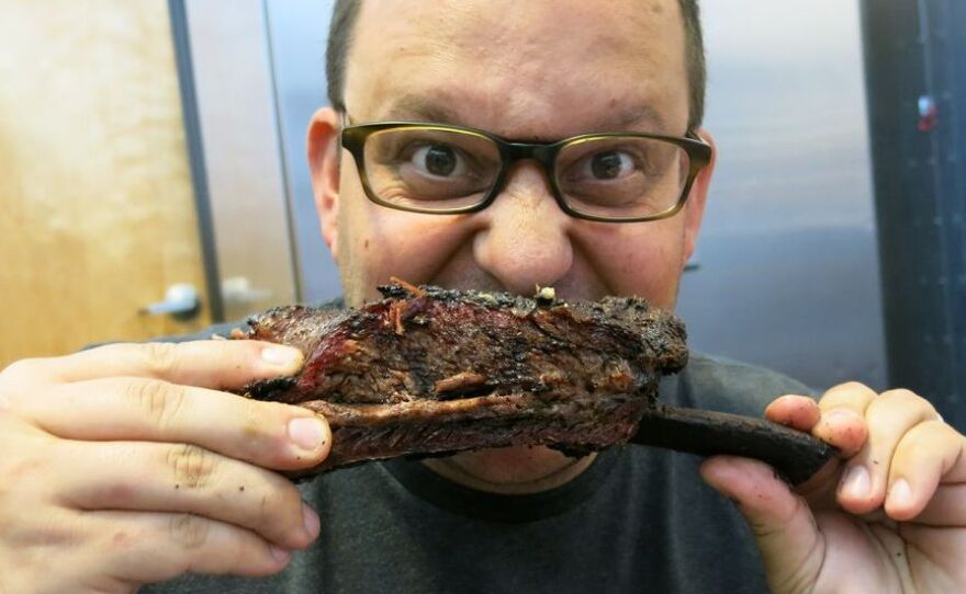 Daniel Vaughn digs into some expertly smoked ribs at the Pecan Lodge.