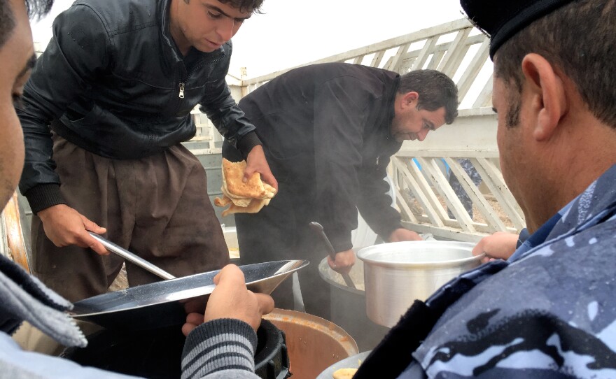SWAT members, shown here at mealtime, live in tents with dirt floors and train without weapons.