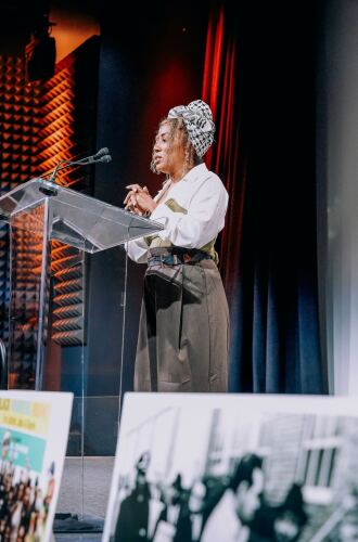 Brisa Johnson, director of the San Diego Black Worker Center, is seen on stage delivering a speech in this undated photo.