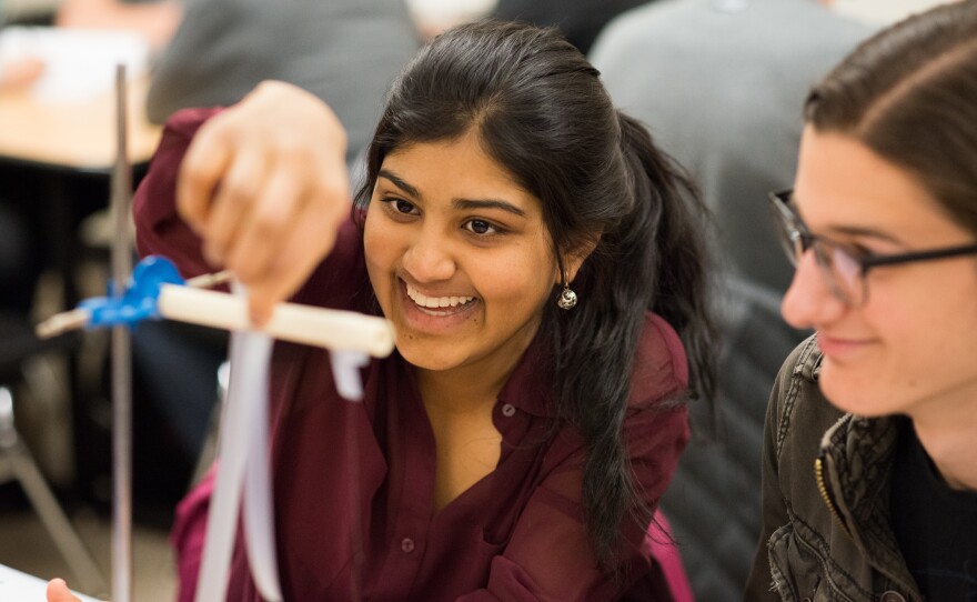 Students Geya Kairamkonda, left, and Patrick Murphy perform an experiment on elecitric charge using Scotch tape during a physics tutorial session. Their class utilizes Learning Assistants as tutors.