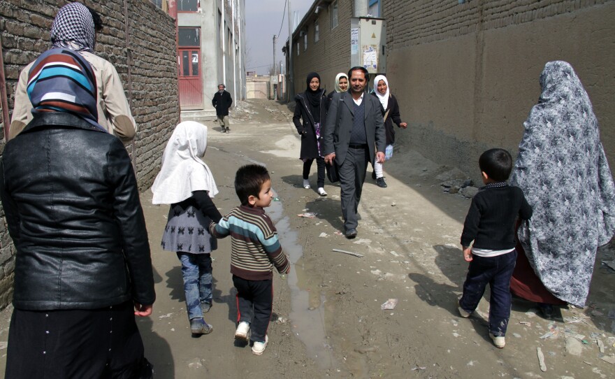 Aziz Royesh (center) in the streets near the Marefat School in Kabul.