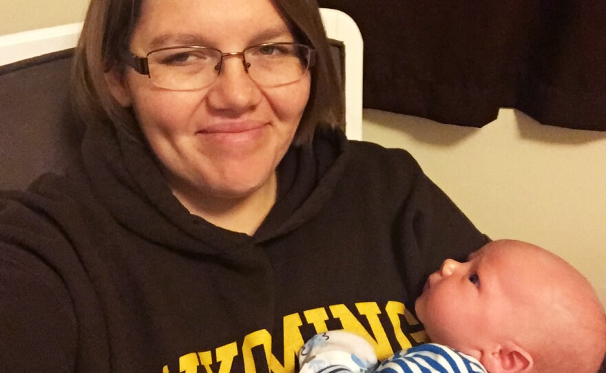 Olson and Gus at home. The new mother is grateful for the time off she received from her job — where she is one of just four employees -- but wishes she could have stayed home longer.