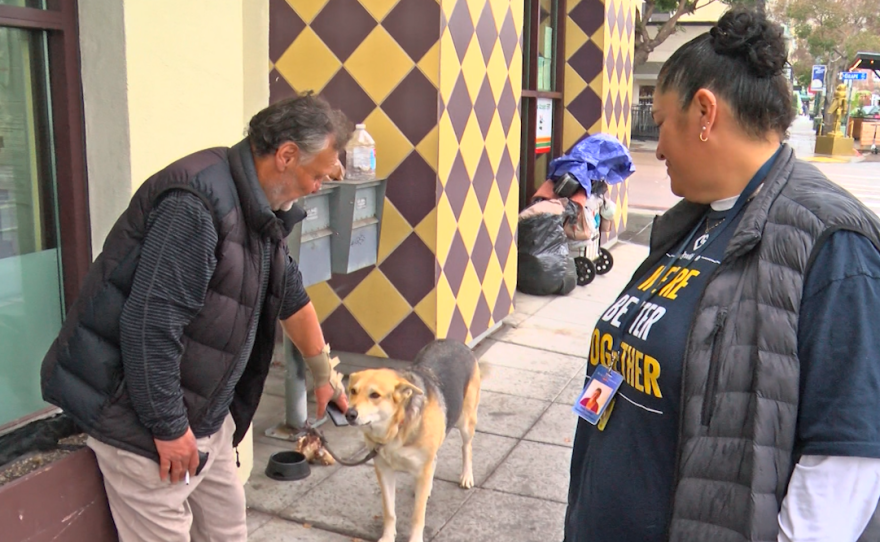 San Diego Rescue Mission outreach employee with homeless man and his dog in .png