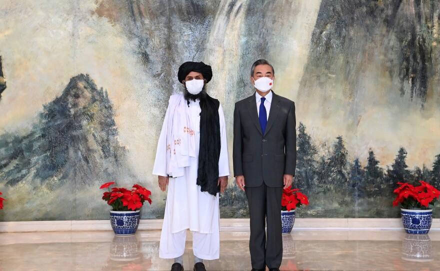 Chinese State Councilor and Foreign Minister Wang Yi (right) meets with senior Afghan Taliban official Mullah Abdul Ghani Baradar in Tianjin, northeastern China, on July 28.