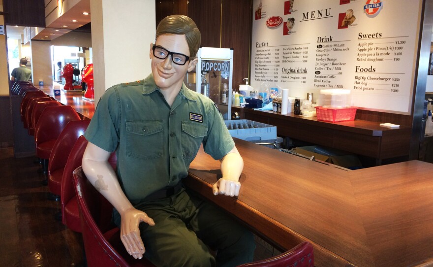 A replica of an American serviceman that sits at the counter of the diner-like Blue Seal ice cream shop.