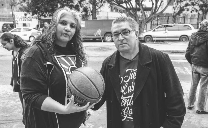 Aracely Villa and Ruben Torres of Love Thy Neighbor pose for a photo during a toy drive in 2016.