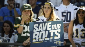 Football fans hold up a "Save Our Bolts" sign during an NFL football game between the San Diego Chargers and the Jacksonville Jaguars in San Diego, Sept. 18, 2016.