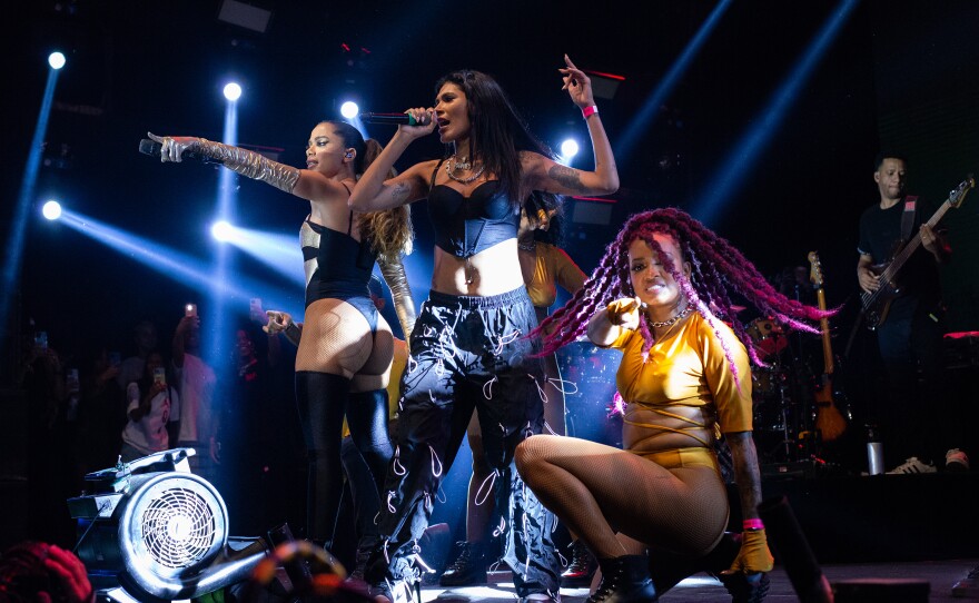 Anitta (left) and singer POCAH (center) perform their new song <em>"Avisa Lá"</em> at Village Festival in Rio de Janeiro on Dec. 4.