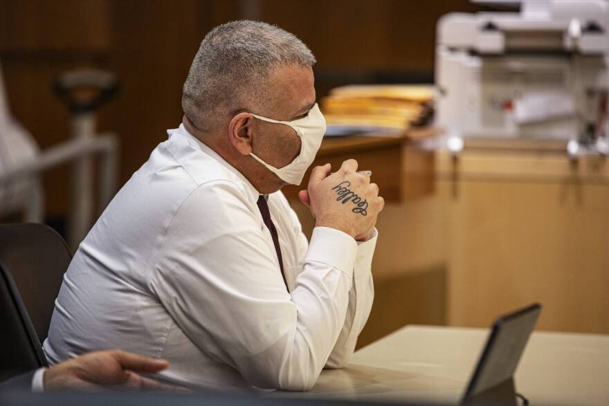 Julio Garay listens to testimonies with his tattoo of his wife’s name, Calley, visible on his hand inside the Madera County Superior Court in Madera, Sept. 29, 2021.