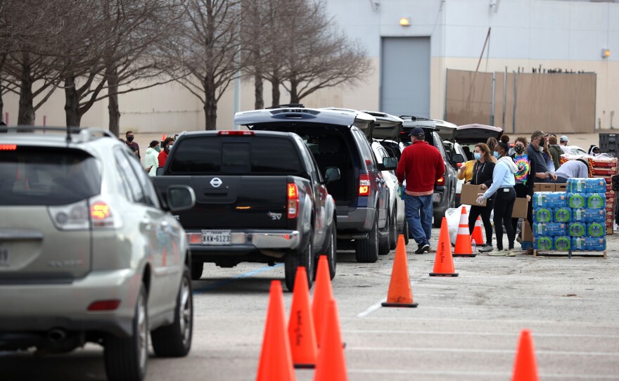 Thousands line up Sunday to receive food and water at a mass distribution site at NRG Stadium for Houston residents who are still without running water and electricity following last week's winter storm.