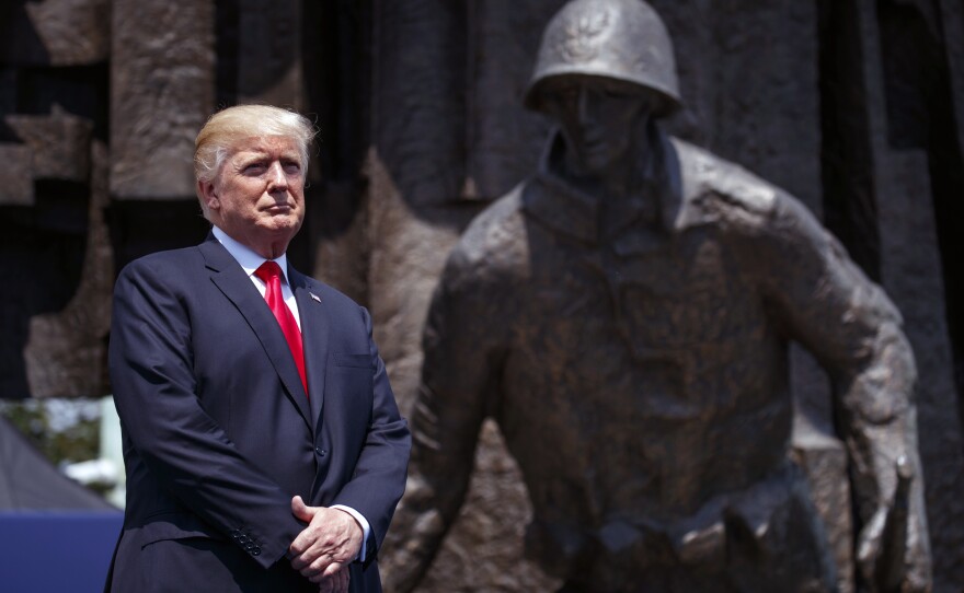 President Donald Trump listens as he is introduced to deliver a speech at Krasinski Square at the Royal Castle, in Warsaw, July 6, 2017.