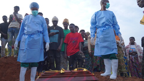 People dressed in protective gear prepare to lower into a grave the coffin containing the remains of 3-year-old Mave Mercienne, who died of Ebola, in Bunia, Ituri province, eastern Congo, Tuesday, Aug. 18, 2026.