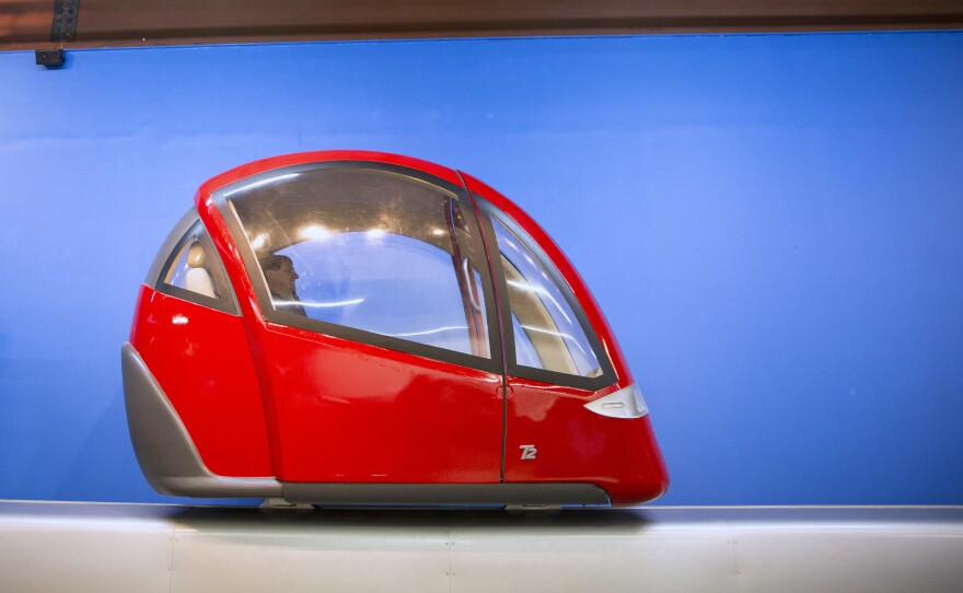 Mike Lester, CEO of Taxi 2000, sits in the SkyWeb Express in the company's warehouse in Fridley, Minn. The company has been working on SkyWeb Express system, a point-to-point personal rapid transit system.