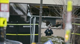 Police work on the scene outside of a King Soopers grocery store where authorities say multiple people were killed in a shooting, Monday, March 22, 2021, in Boulder, Colo.