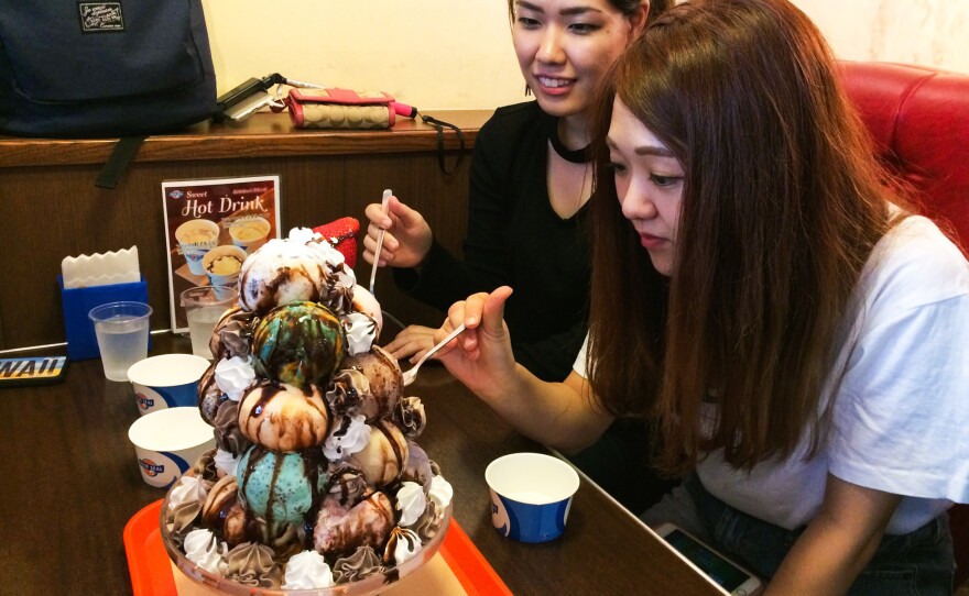Two Okinawan college students dig into their seventeen scoop ice cream treat.
