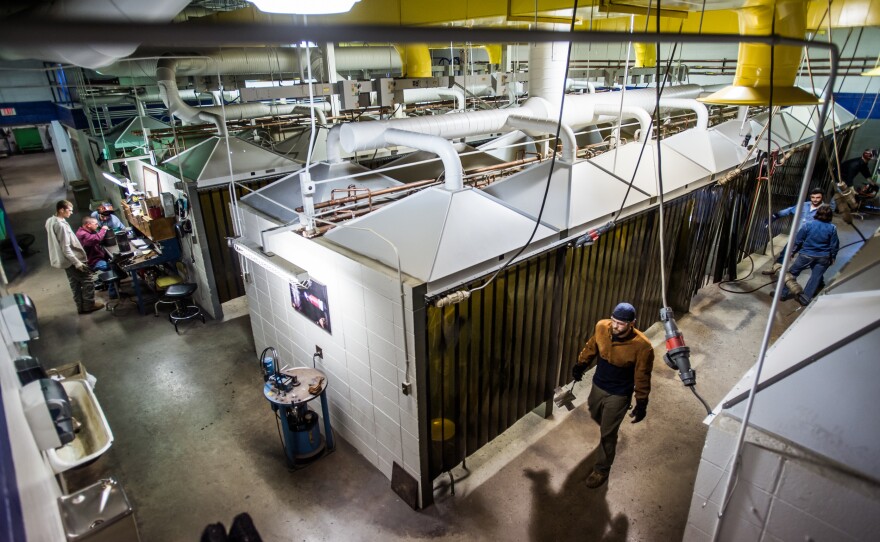 Harris walks through the workspace of his welding class at Spartanburg Community College.