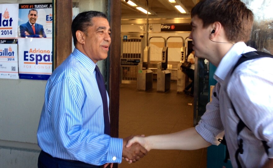 State Senator Adriano Espaillat greets voters at a subway stop in upper Manhattan